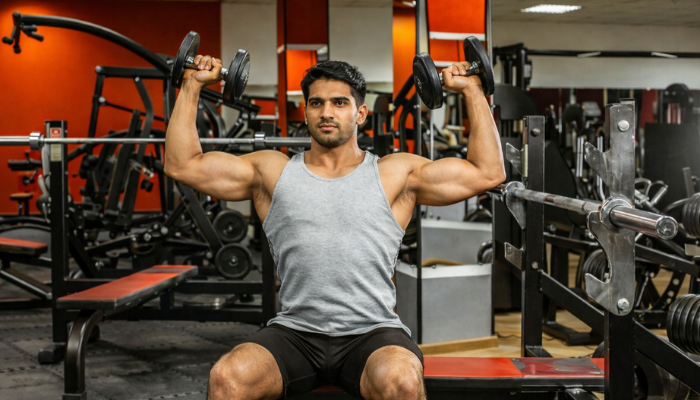 Man doing arnold press exercise in gym