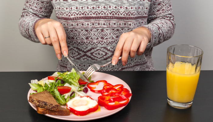 A female having healthy meal with juice