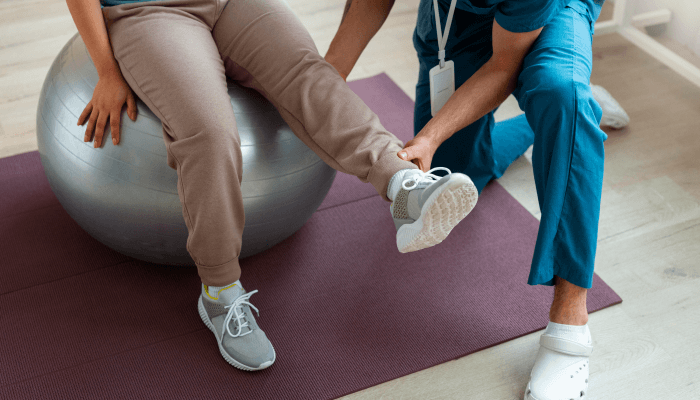 A instructor helping a man during stretching 