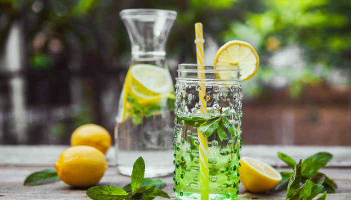 lemon water in a glass with mint 