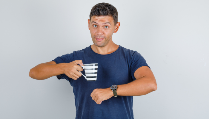 young-man-dark-blue-t-shirt-gesturing-time-before-coffee-drink