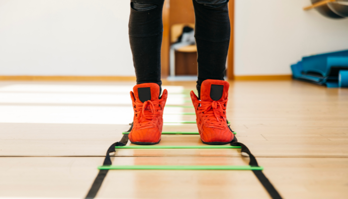 A man performing step touches exercise in gym 