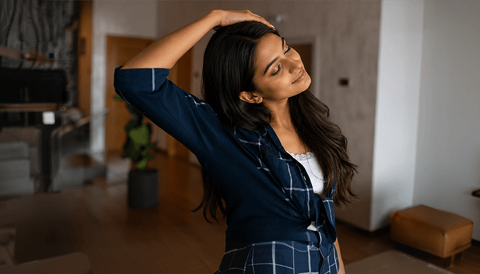woman doing Side tilt exercise for neck pain 