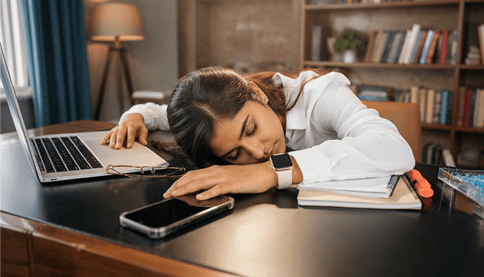 A young female sleeping on work desk after work