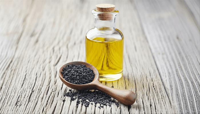 kalonji oil in a glass jar bottle for hair growth