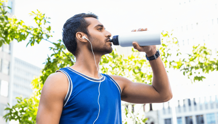 fit man drinking water from bottle