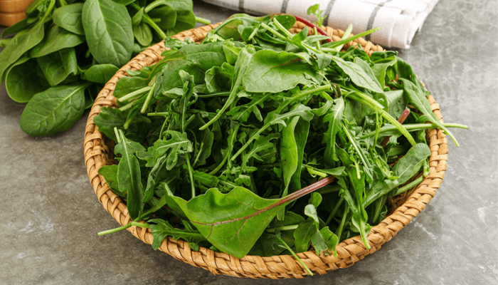 fresh spinich leaves in a jute basket