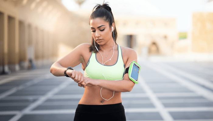 girl monitoring heart rate on smart watch